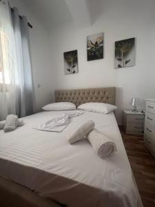 a large white bed with two towels on it at Villa Zoto in Himare +19 photos