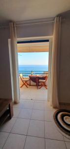 an open door to a room with a view of the ocean at Glyfada Beach House in Glyfada