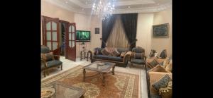 a living room with a couch and chairs and a table at استراحة زين in Al Madinah