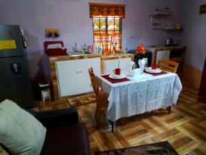 a kitchen with a table with a white table cloth at palms in Jerningham Junction