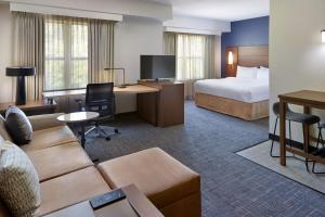 a hotel room with a couch and a bed and a desk at Residence Inn Asheville Biltmore in Asheville