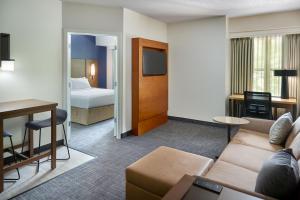 a hotel room with a couch and a bed at Residence Inn Asheville Biltmore in Asheville