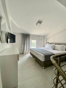 a bedroom with a large bed and a television at INTERNI LUXURY LIVING in Nikiti +79 photos