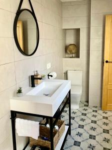 a bathroom with a white sink and a mirror at Sagunto Castillo 17 in Sagunto