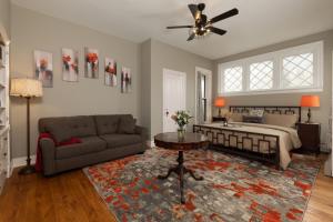 a living room with a bed and a couch at Rosemont Inn in Utica