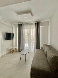 a living room with a couch and a table at INTERNI LUXURY LIVING in Nikiti