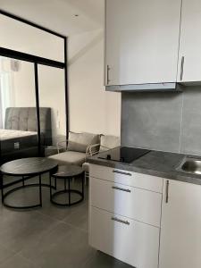 a kitchen with a table and a couch in a room at JV Athens in Athens