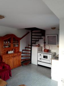 a kitchen with a staircase and a white refrigerator at Idiličan brijeg in Višegrad
