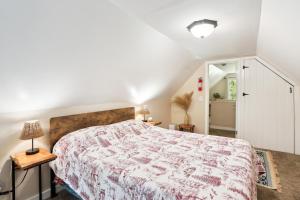 a bedroom with a large bed with a floral bedspread at Twin Peaks Vacation Rental with Hot Tub! in Twin Peaks