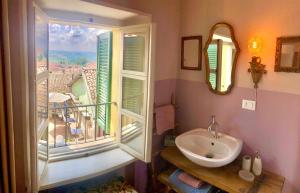 a bathroom with a sink and a window with a view at LA GIALLA di Via Silvano 12 in Monforte dʼAlba