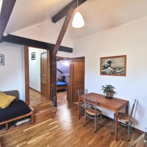 a dining room and living room with a table and chairs at Surfworx Lodge in Soustons