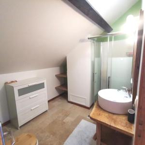 a bathroom with a white sink and a shower at Surfworx Lodge in Soustons