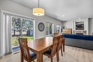 a dining room with a table and chairs and a couch at Edro Place in Bend