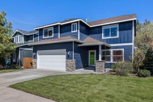 a blue house with a white garage at Edro Place in Bend