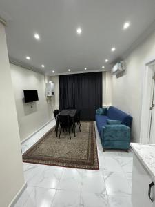 a living room with a table and a blue couch at CEM OTEL in Istanbul