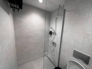 a bathroom with a shower and a toilet at SuprStay - Belgrade Waterfront Luxury Studio in Belgrade