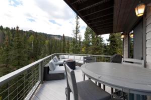 a patio with a table and chairs on a balcony at 1601 Lake Purgatory Drive in Durango