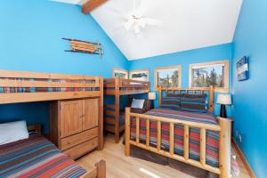 a bedroom with two bunk beds and blue walls at 1601 Lake Purgatory Drive in Durango