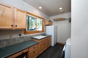 a kitchen with wooden cabinets and a white refrigerator at 1601 Lake Purgatory Drive in Durango +66 photos