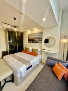 ein Schlafzimmer mit einem großen Bett und einem Sofa in der Unterkunft Verdela Pollux Meisterstadt Batam apartement in Batam Center
