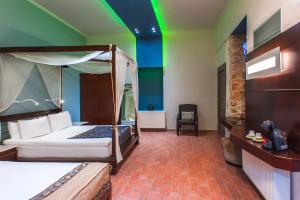 a bedroom with a canopy bed and a green ceiling at Splanzia Boutique Hotel in Chania