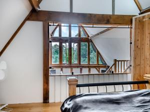 um quarto com uma cama e uma janela em Elms Barn em Saint James