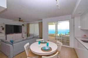 a living room with a table and a couch at THE SEA VIEW CALACEITE in Torrox Costa
