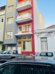 a red building with cars parked in front of it at Perfect City Center in Praia