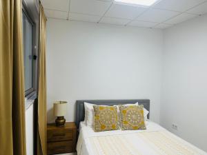 a bedroom with a bed with yellow pillows at Perfect City Center in Praia