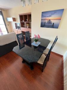 a dining table and chairs in a living room at Las Marinas, apartamento muy amplio cerca de la playa in Benidorm