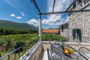 a balcony with a table with a bowl of fruit at Villa Le Adria - Private HotTub - Free Beach Parking in Kozica