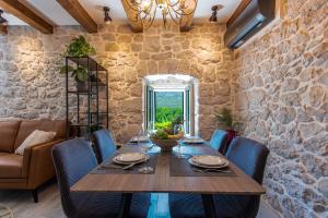 a dining room with a wooden table and chairs at Villa Le Adria - Private HotTub - Free Beach Parking in Kozica +42 photos