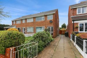 a brick house with a fence in front of it at Superb 3 bed house, with homely comforts and secure parking on gated premise in Sheffield