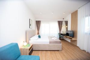a hotel room with a bed and a tv at Apartments Sirena in Budva