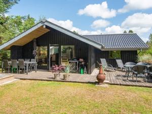 a house with a wooden deck with a patio at 6 person holiday home in N rre Nebel in Nørre Nebel