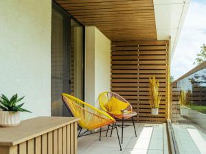 a patio with two chairs and a table on a balcony at Bond Apartment - Astria Olimp in Olimp
