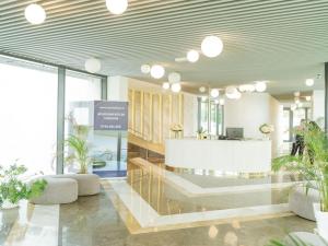 a lobby with a reception desk and potted plants at Bond Apartment - Astria Olimp in Olimp