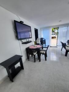 a living room with a flat screen tv on a wall at CASA VACACIONAL Babilonia in Girardot