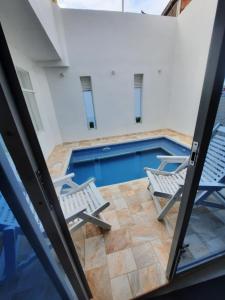 a view of a swimming pool from inside a house at CASA VACACIONAL Babilonia in Girardot