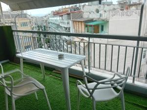 a table and two chairs on a balcony at Art Suite 7 in Thessaloniki