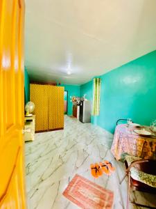 a bedroom with blue walls and a marble floor at Budget-StudioRoom-Panabo-Homestay in Panabo