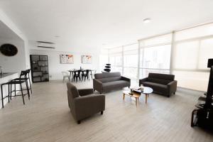 a living room with two couches and a table at Boutique Apartments Panama Atlapa in Panama City