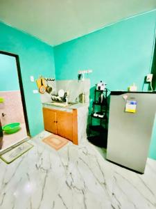 a bathroom with a marble floor and a sink at Budget-StudioRoom-Panabo-Homestay in Panabo