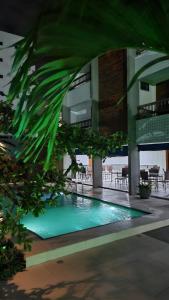 a swimming pool in the middle of a building at Pousada Costa Marina in Fortaleza