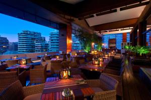 a restaurant with tables and chairs and a view of the city at W Santiago in Santiago