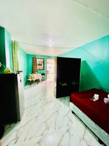 a bedroom with a bed and a table in a room at Budget-StudioRoom-Panabo-Homestay in Panabo
