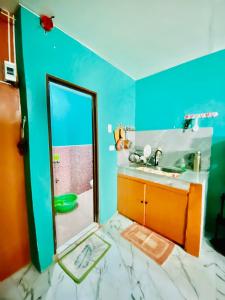 a bathroom with a mirror and a sink at Budget-StudioRoom-Panabo-Homestay in Panabo