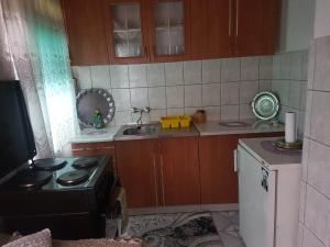 a small kitchen with a stove and a sink at Subaša in Visoko
