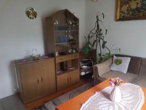 a living room with a cabinet and a table at Subaša in Visoko