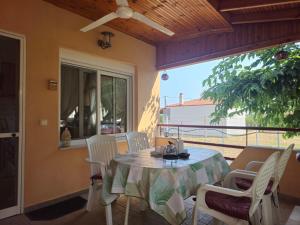 a dining room with a table and chairs on a patio at Spyros comfy and cool place in Karianí +36 photos